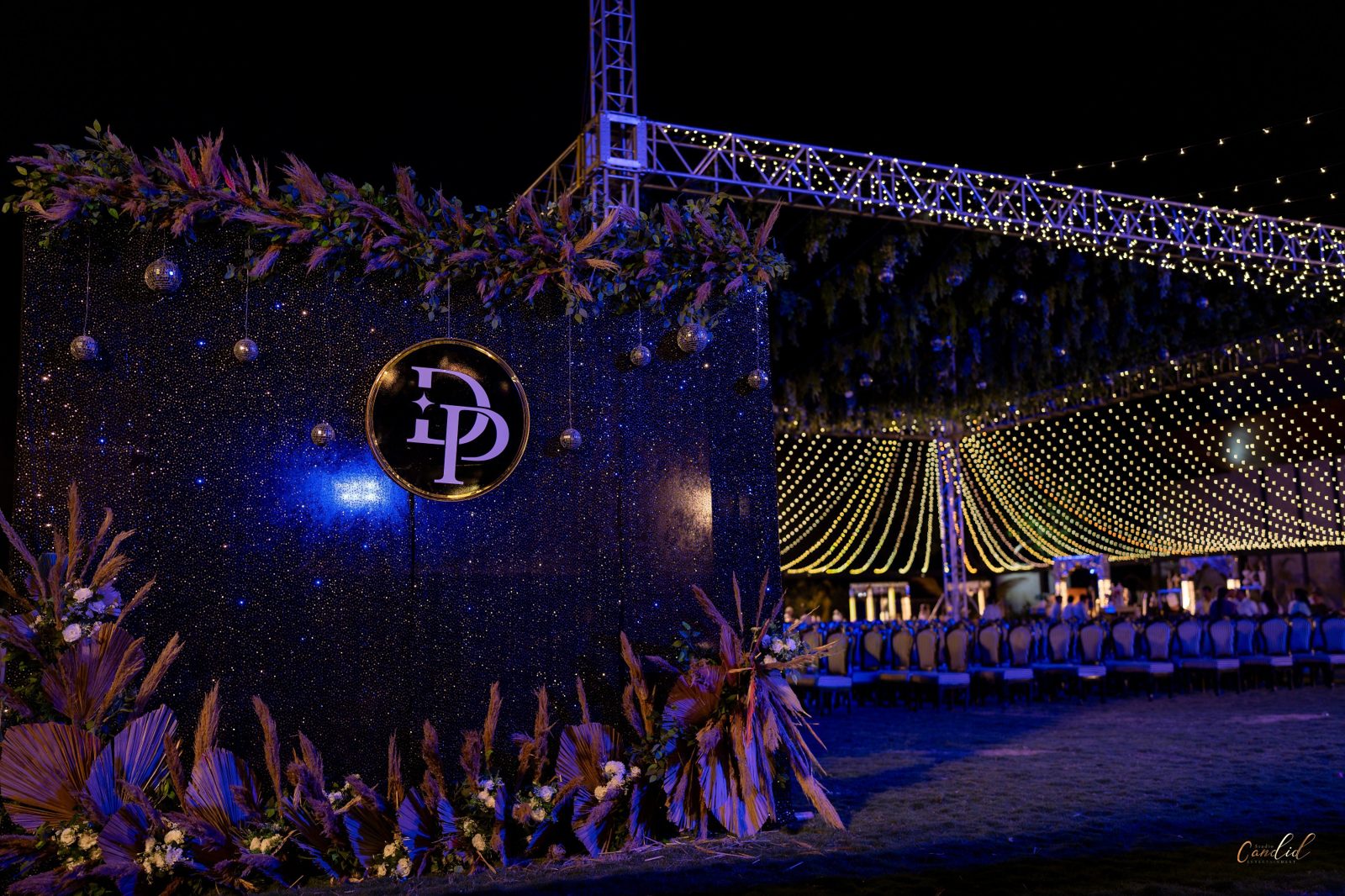 Dancers performing beneath illuminated stage letters