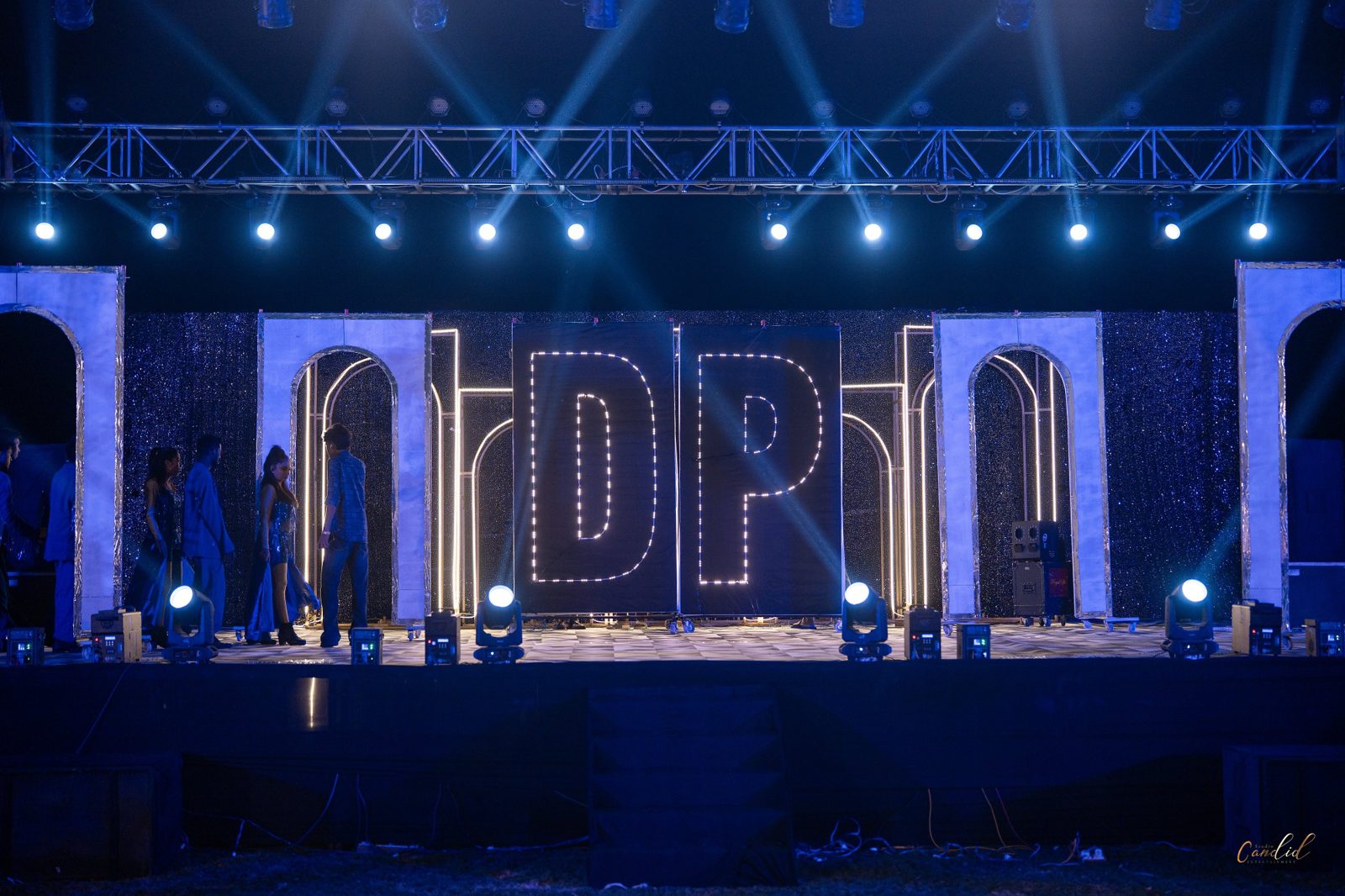 Hand-painted peacock mandap backdrop with monogram and floral garlands